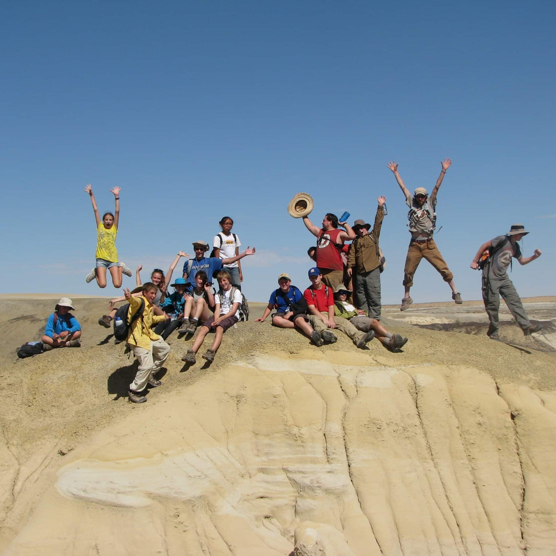 Children and staff at Cottonwood Gulch pose for a group portrait in the desert.